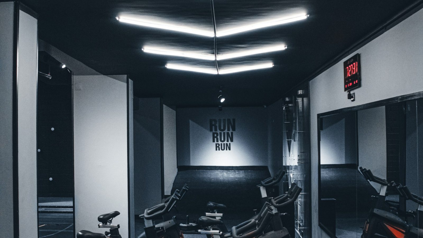 A dark gym corridor lit by strip lights